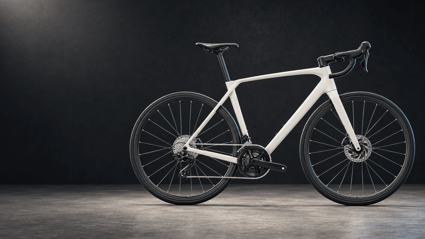 White carbon endurance road bike in a dark studio