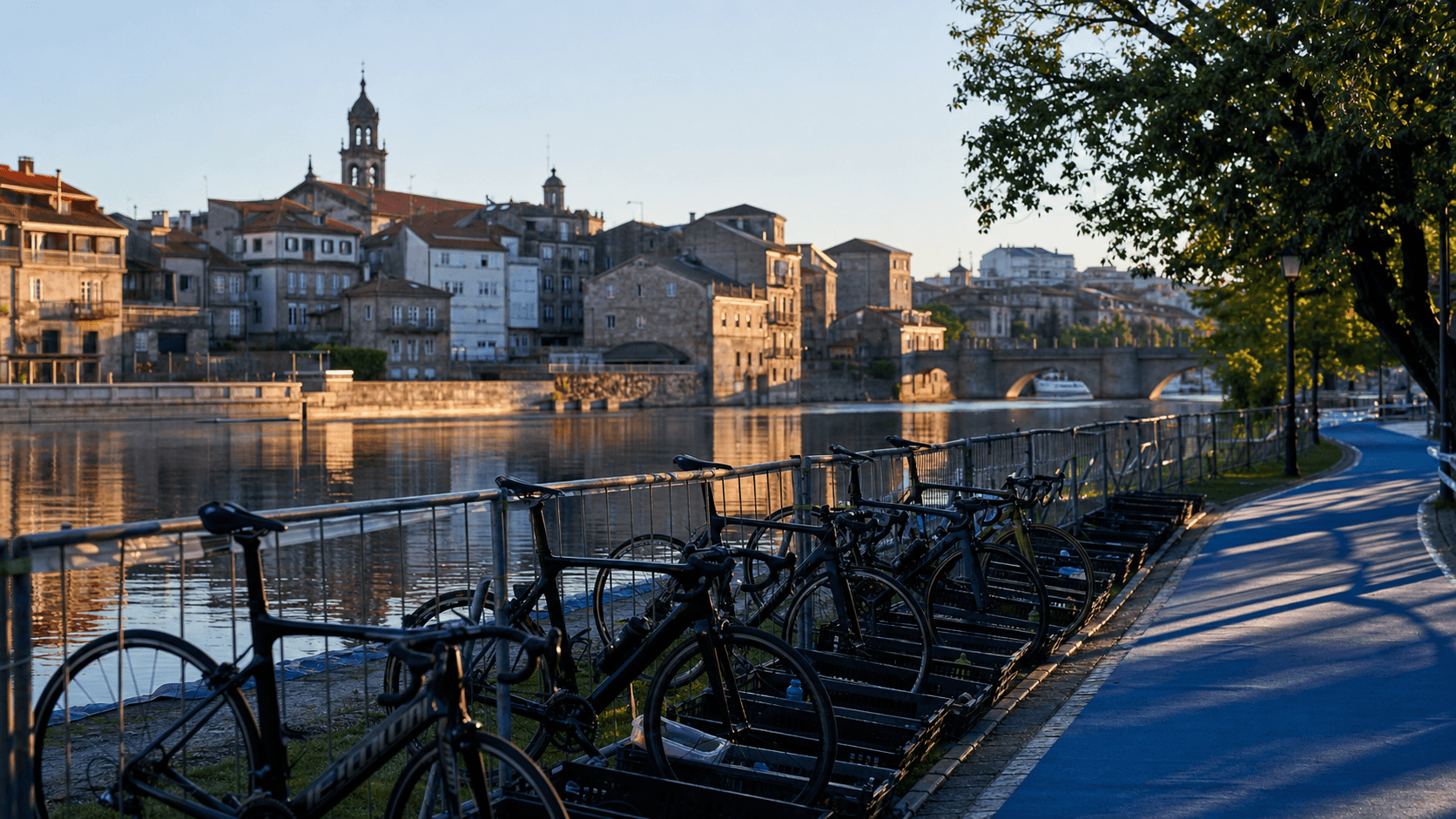 Unbranded triathlon transition area beside the Pontevedra riverside and old town at dawn